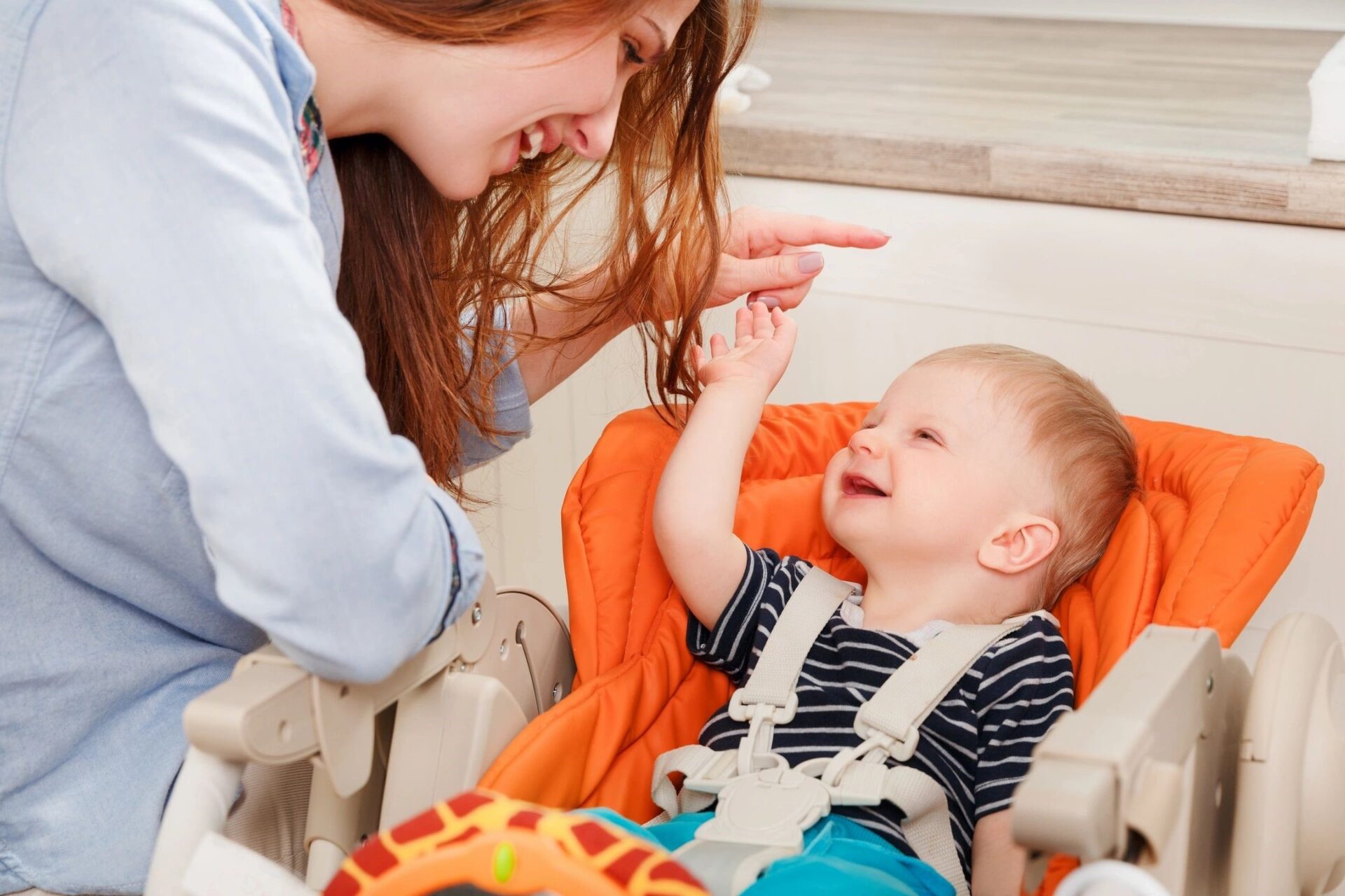 A women playing with a baby