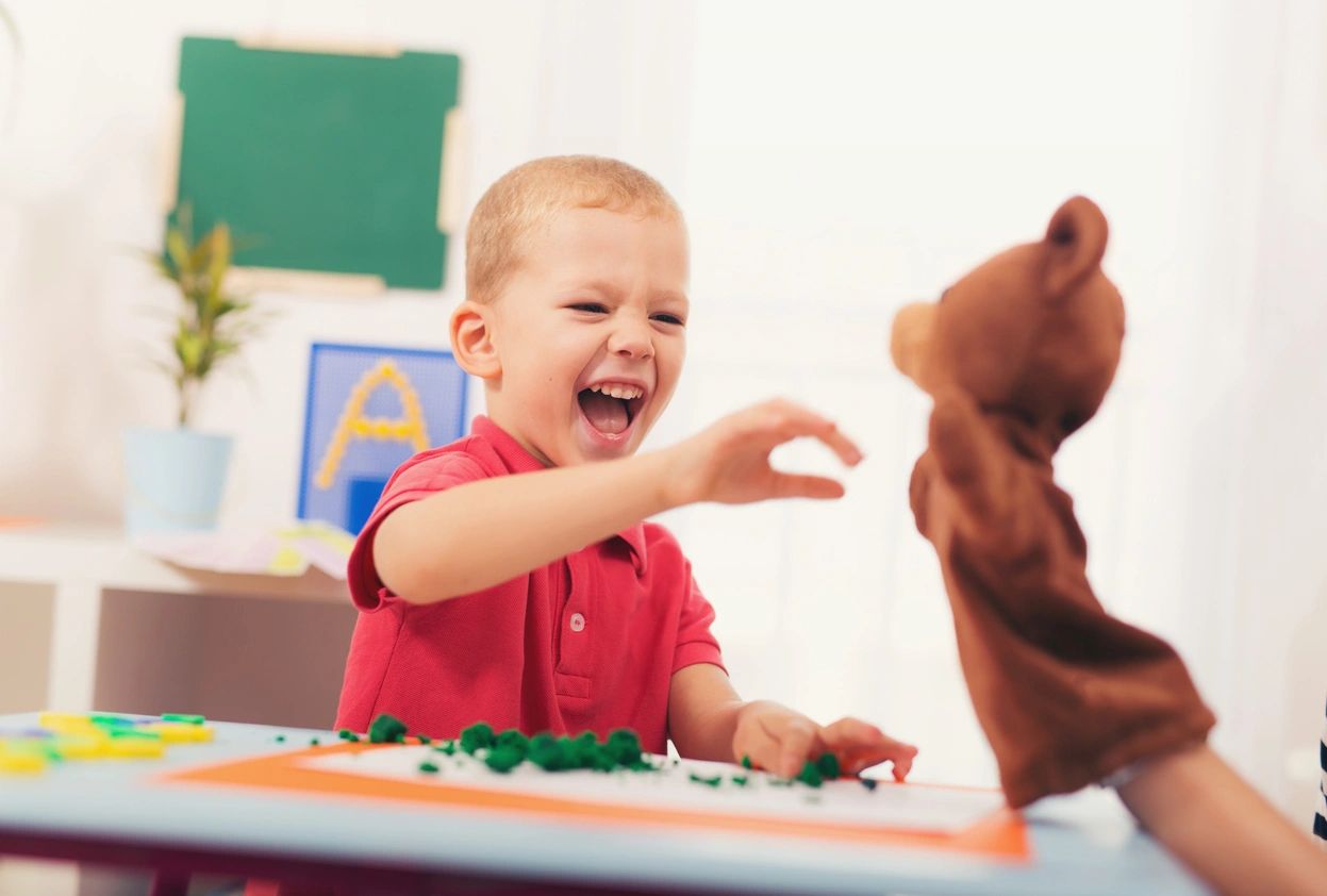 A kid with red colored T-Shirt playing